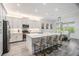 Bright, modern kitchen with white cabinets, stainless steel appliances, and a large center island at 3197 Acacia Bay Ave, Wesley Chapel, FL 33543