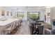 Open-concept living space featuring a modern kitchen island and a comfortable seating area at 3197 Acacia Bay Ave, Wesley Chapel, FL 33543