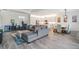 Open-concept living space showcasing a modern kitchen, dining area, and comfortable living room with stylish furnishings at 3197 Acacia Bay Ave, Wesley Chapel, FL 33543