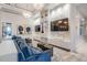 Bright resident lounge featuring comfortable blue couches, contemporary art and sleek built-ins at 3197 Acacia Bay Ave, Wesley Chapel, FL 33543