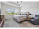 Bright main bedroom featuring tray ceiling, carpet, and a large window for natural light at 3197 Acacia Bay Ave, Wesley Chapel, FL 33543