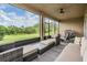 Relaxing screened-in patio with comfortable seating, a ceiling fan, and a view of the lush backyard at 3197 Acacia Bay Ave, Wesley Chapel, FL 33543