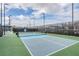 Well-maintained pickleball court is surrounded by landscaping, offering a fun and active recreational opportunity at 3197 Acacia Bay Ave, Wesley Chapel, FL 33543