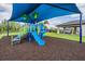 A vibrant blue playground is designed for safe play and covered for sun protection, offering a fun outdoor activity at 3197 Acacia Bay Ave, Wesley Chapel, FL 33543