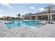 A refreshing pool surrounded by lounge chairs and palm trees provides a perfect spot for relaxation and recreation at 3197 Acacia Bay Ave, Wesley Chapel, FL 33543