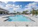 Resort-style pool featuring sun loungers, palm trees, and shaded cabanas, offering a relaxing oasis at 3197 Acacia Bay Ave, Wesley Chapel, FL 33543