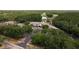 Gorgeous aerial view of community clubhouse, golf course, tennis courts, and lush green landscaping at 3337 Crescent Oaks Blvd, Tarpon Springs, FL 34688