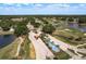 Aerial shot of a grand community entrance with water features and a golf course in the background at 3337 Crescent Oaks Blvd, Tarpon Springs, FL 34688