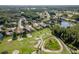 An aerial view of homes near a golf course featuring sand traps, ponds, and lush landscaping at 3337 Crescent Oaks Blvd, Tarpon Springs, FL 34688