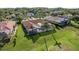 Aerial view of a private home with screened lanai, mature trees, and lush green lawn at 3337 Crescent Oaks Blvd, Tarpon Springs, FL 34688