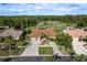 Stunning aerial view of single-story home with tile roof, golf course views and mature landscaping at 3337 Crescent Oaks Blvd, Tarpon Springs, FL 34688