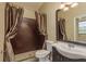 Bathroom with mosaic tile shower, curtain, vanity, mirror, toilet, and lighting fixture at 3337 Crescent Oaks Blvd, Tarpon Springs, FL 34688