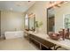 Bathroom with double vanity, soaking tub and neutral color scheme at 3337 Crescent Oaks Blvd, Tarpon Springs, FL 34688