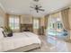 Well-lit bedroom with large windows and sliding doors leading to lanai with a pool view at 3337 Crescent Oaks Blvd, Tarpon Springs, FL 34688