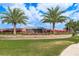Community entrance featuring the 'Crescent Oaks' sign surrounded by vibrant, colorful landscaping at 3337 Crescent Oaks Blvd, Tarpon Springs, FL 34688