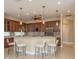An open-concept kitchen boasts a large island, bar seating, pendant lighting and modern stainless steel appliances at 3337 Crescent Oaks Blvd, Tarpon Springs, FL 34688