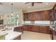 Kitchen showcasing granite countertops, stainless appliances, and a mosaic backsplash, illuminated by natural light at 3337 Crescent Oaks Blvd, Tarpon Springs, FL 34688