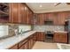 Contemporary kitchen featuring wooden cabinets, stainless appliances, mosaic backsplash, and bright white countertops at 3337 Crescent Oaks Blvd, Tarpon Springs, FL 34688