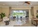 Bright living room with seating area that overlooks the pool at 3337 Crescent Oaks Blvd, Tarpon Springs, FL 34688
