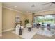 Bright living room with seating area that overlooks the pool at 3337 Crescent Oaks Blvd, Tarpon Springs, FL 34688