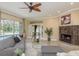 Bright living room with fireplace and access to pool at 3337 Crescent Oaks Blvd, Tarpon Springs, FL 34688