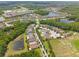 A serene aerial view showcasing a residential area nestled amongst picturesque lakes and verdant landscaping at 3532 Wicket Field Rd, Lutz, FL 33548