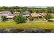 Backyard view featuring fenced yard, paver patio, and pond at 3532 Wicket Field Rd, Lutz, FL 33548