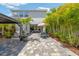 Expansive backyard with patio, gazebo, hot tub, lush landscaping, and paver outdoor seating area at 3532 Wicket Field Rd, Lutz, FL 33548