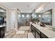 Beautiful bathroom featuring dual sinks, granite countertops, a glass shower, and luxury wood-look flooring at 3532 Wicket Field Rd, Lutz, FL 33548
