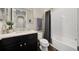 Bathroom features a dark vanity with granite countertop, subway tile shower, and wood-look tile flooring at 3532 Wicket Field Rd, Lutz, FL 33548