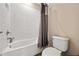 Standard bathroom featuring a shower-tub combo with white tiling and a gray shower curtain at 3532 Wicket Field Rd, Lutz, FL 33548