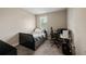 Bedroom setup with neutral colors, a window, carpet, a desk, and a black-and-white gaming chair at 3532 Wicket Field Rd, Lutz, FL 33548