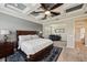 Bedroom featuring a coffered ceiling, a king bed, and a sitting area at 3532 Wicket Field Rd, Lutz, FL 33548