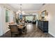 Elegant dining room featuring hardwood floors, modern lighting, and an open floor plan at 3532 Wicket Field Rd, Lutz, FL 33548