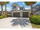 Attractive home with a three-car garage, stone accents, and manicured landscaping at 3532 Wicket Field Rd, Lutz, FL 33548