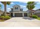Charming two-story home with a three-car garage, complemented by lush tropical landscaping at 3532 Wicket Field Rd, Lutz, FL 33548