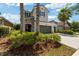 Inviting two-story home with lush landscaping and a stone-accented entryway at 3532 Wicket Field Rd, Lutz, FL 33548