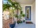 Welcoming front porch featuring a decorative glass door and attractive landscaping at 3532 Wicket Field Rd, Lutz, FL 33548