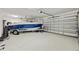 Spacious garage featuring epoxy flooring, a boat on a trailer, and a garage door at 3532 Wicket Field Rd, Lutz, FL 33548