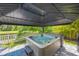 Inviting hot tub under gazebo offering serene backyard views and privacy at 3532 Wicket Field Rd, Lutz, FL 33548
