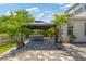 Relaxing hot tub in covered gazebo with surrounding lush landscaping and paver patio at 3532 Wicket Field Rd, Lutz, FL 33548