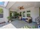 Covered lanai with ceiling fan, outdoor seating, and stainless steel grill at 3532 Wicket Field Rd, Lutz, FL 33548
