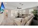 Upstairs living room with a large sectional, neutral carpet, and an open railing at 3532 Wicket Field Rd, Lutz, FL 33548