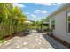 Paver patio features outdoor dining, seating area, and lush landscaping with a picturesque pond view at 3532 Wicket Field Rd, Lutz, FL 33548