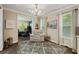 Bright sitting room with comfortable armchair, neutral decor, and hardwood floors at 3532 Wicket Field Rd, Lutz, FL 33548