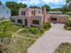Aerial view showcasing the home's architecture, landscaping, and brick driveway at 43 Edgewater Dr, Dunedin, FL 34698