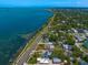 Stunning aerial view highlighting the waterfront location, community, and nearby docks at 43 Edgewater Dr, Dunedin, FL 34698