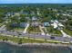 Gorgeous aerial showcases the property's prime location near the waterfront in a lush, green neighborhood at 43 Edgewater Dr, Dunedin, FL 34698