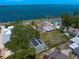 Beautiful bird's eye view showing the house's roof, backyard, and stunning water view at 43 Edgewater Dr, Dunedin, FL 34698