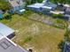 Aerial view of the spacious backyard that features ample greenery and mature trees for privacy at 43 Edgewater Dr, Dunedin, FL 34698